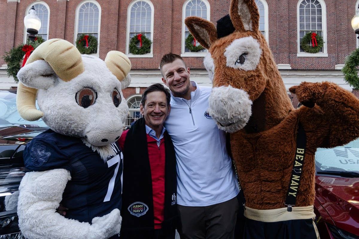 USAA CEO Wayne Peacock with USAA spokesperson Rob Gronkowski and the Army and Navy mascots following the Recycled Rides event at the Army-Navy pep rally where USAA and Gronk presented donated vehicles to two military families in need. Photo/USAA