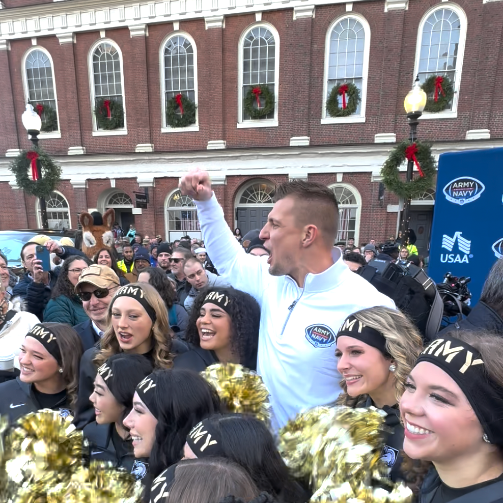 Rob Gronkowski with the Army cheerleaders at the USAA's Recycled Rides pep rally for the 2023 Army-Navy game. Photo courtesy of USAA