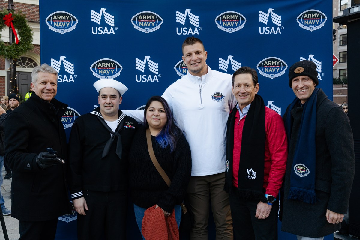 Gronk poses with Navy Petty Officer Kyle Kohlgraf and family, alongside USAA's Wayne Peacock and Bill White