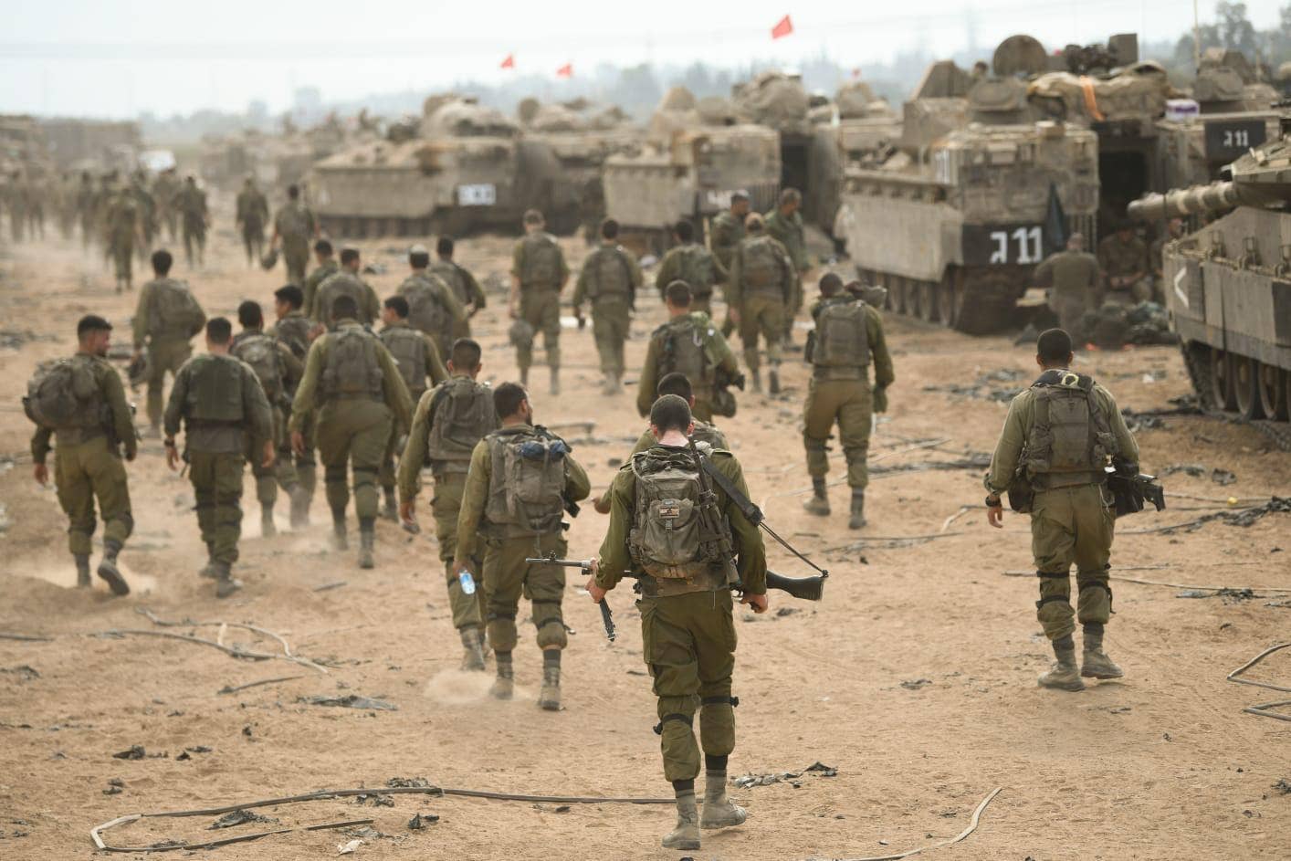 IDF infantry soldiers walk on dirt