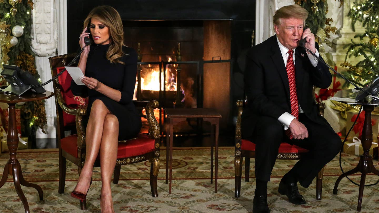 President Donald Trump and first lady Melania Trump speak on the phone with children as they track Santa Claus on Christmas Eve 2018. (Photo by Oliver Contreras/For The Washington Post via Getty Images)
