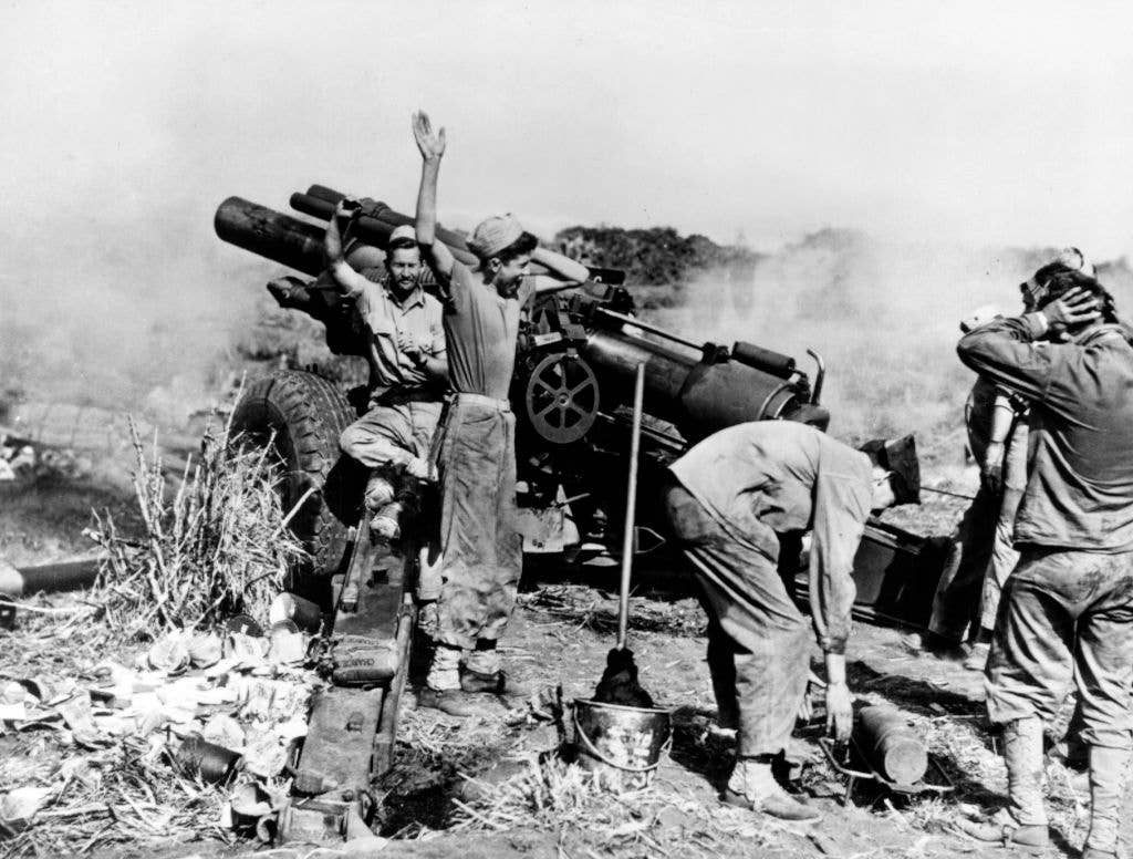 A 155mm Howitzer M1 of the 5th Marine Division, V Amphibious Corps, United States Marine Corps, fires. During the Battle of Iwo Jima on 24th February 1945 on the island of Iwo Jima, Japan. (Photo by INP/Bettmann Archive/Getty Images)