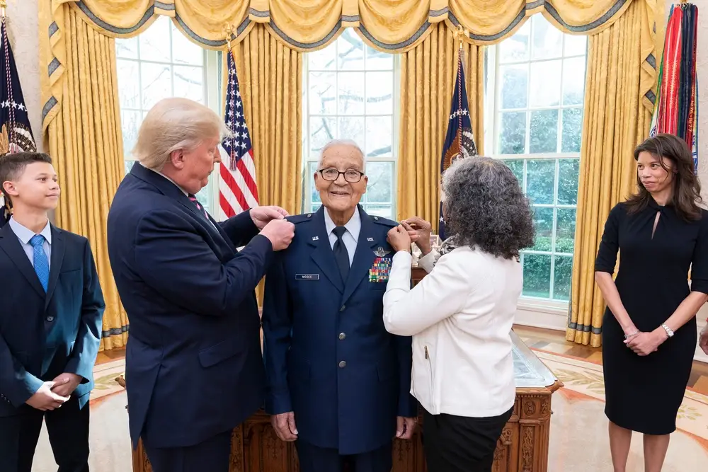 President Donald J. Trump participates in the promotion pinning ceremony for State of the Union Gallery guest retired Tuskegee Airman veteran Brigadier General Charles McGee of Bethesda, Md. Tuesday, Feb. 4, 2020, in the Oval Office of the White House. (Official White House Photo by Shealah Craighead)