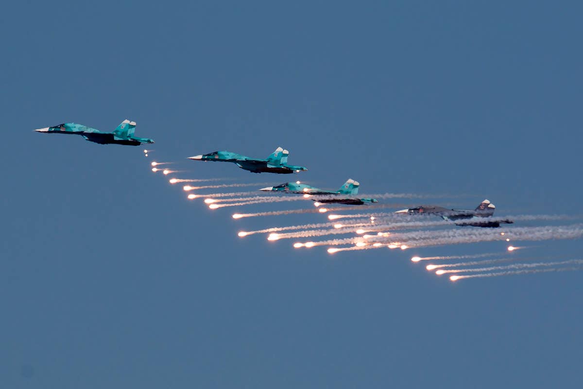 Russian SU-34s fly in formation with flares