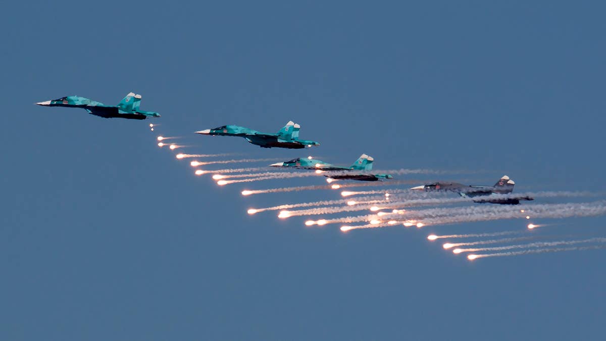 Russian SU-34s fly in formation with flares
