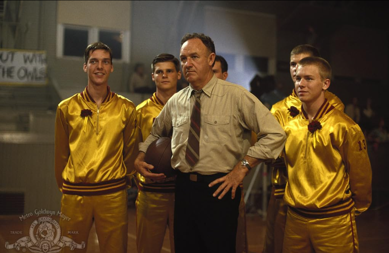 a screenshot from the film Hoosiers with Gene Hackman and his basketball team