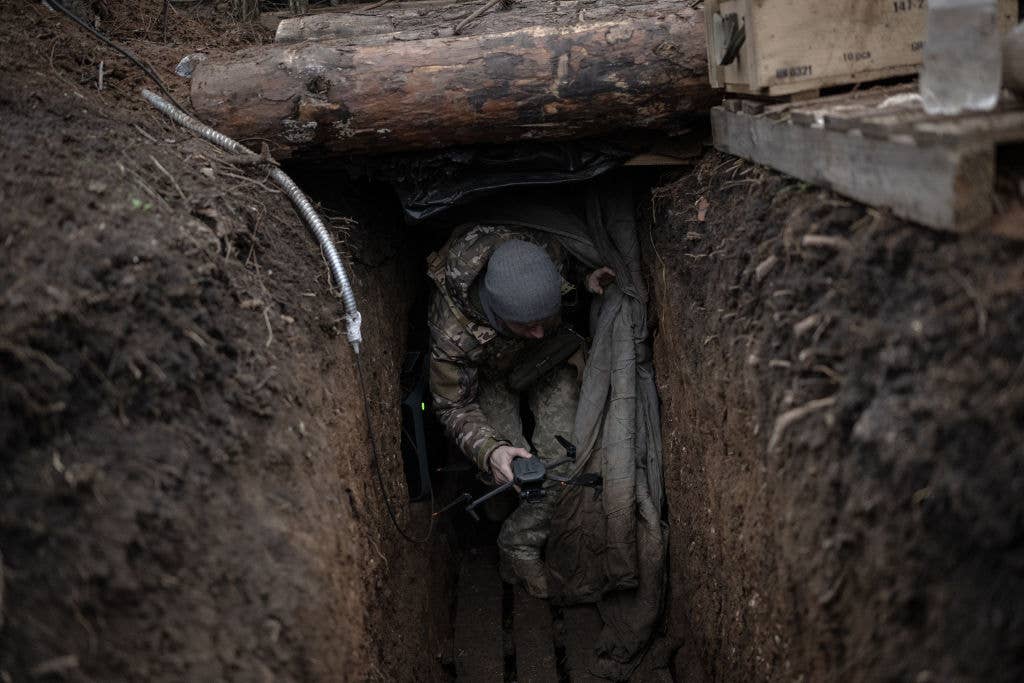 ZAPORIZHIA, UKRAINE - DECEMBER 05: Ukrainian soldiers in their fighting position at the trench use drones for surveillance and offense on the frontline in Zaphorizhia, Ukraine on December 05, 2023. (Photo by Ozge Elif Kizil/Anadolu via Getty Images)