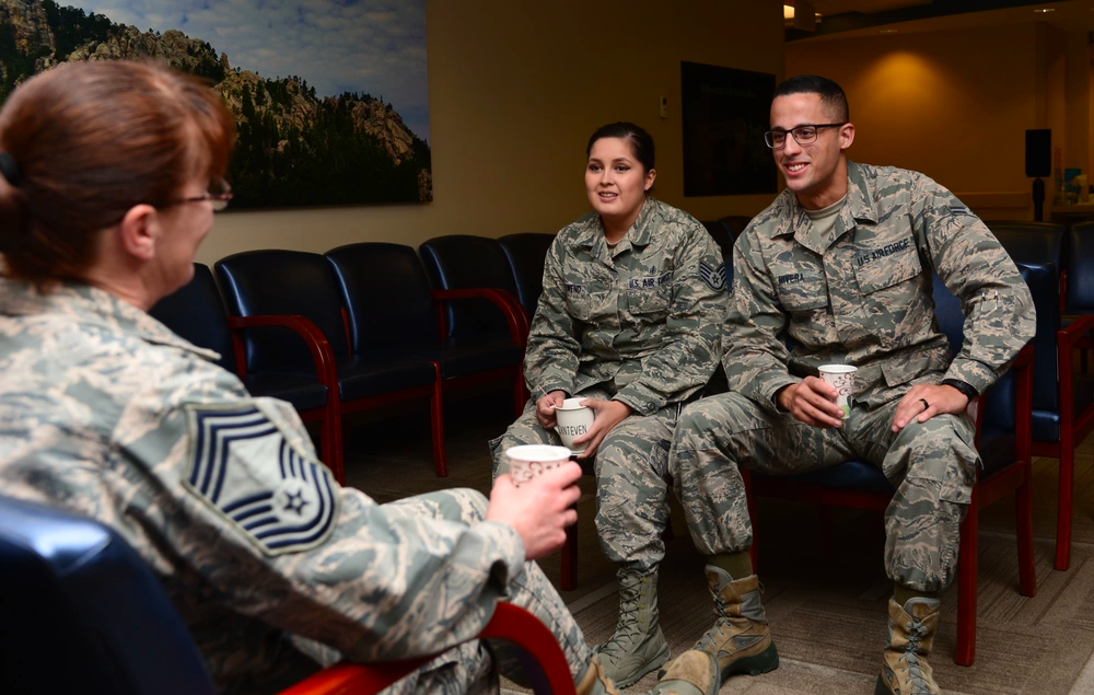 Airmen speak with Chief Master Sgt. Tracey House, the superintendent assigned to the 28th Medical Group, over a cup of coffee during a “Coffee with the Commanders” event at Ellsworth Air Force Base, S.D., Nov. 20, 2017. (U.S. Air Force photo by Airman 1st Class Donald C. Knechtel)