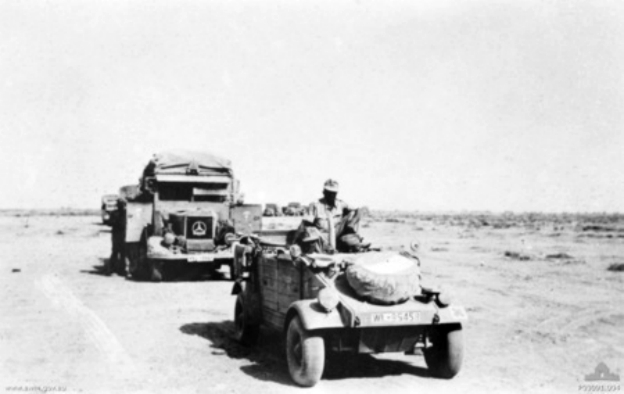 A convoy of Afrika Korps vehicles moving through the desert. The vehicles normally traveled at intervals of approximately one hundred meters in case of an air attack, which, in the case of this photograph, was apparently unlikely. The convoy is lead by a VW Kübelwagen. Wikimedia Commons.