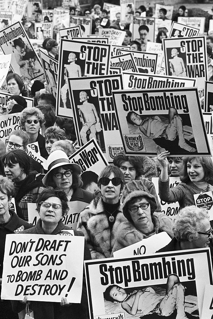 (Original Caption) Carrying graphically illustrated anti-Vietnamese war posters, members of the "Women's Strike for Peace" push their way to the doors of the Pentagon Building. The main doors of the building were locked for 30 minutes, as the women stormed the doors in an effort to gain entrance. This photo is a close-up of the group.
