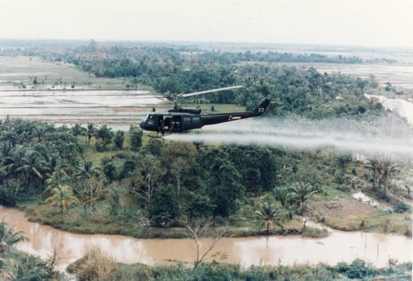 A military helicopter spraying Agent Orange during the Vietnam War. U.S. Army photo, 1963.