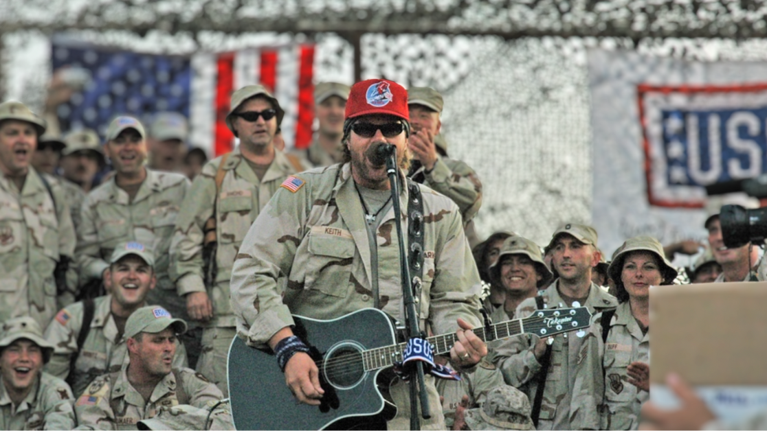 Toby Keith performs the guitar and singing in front of troops