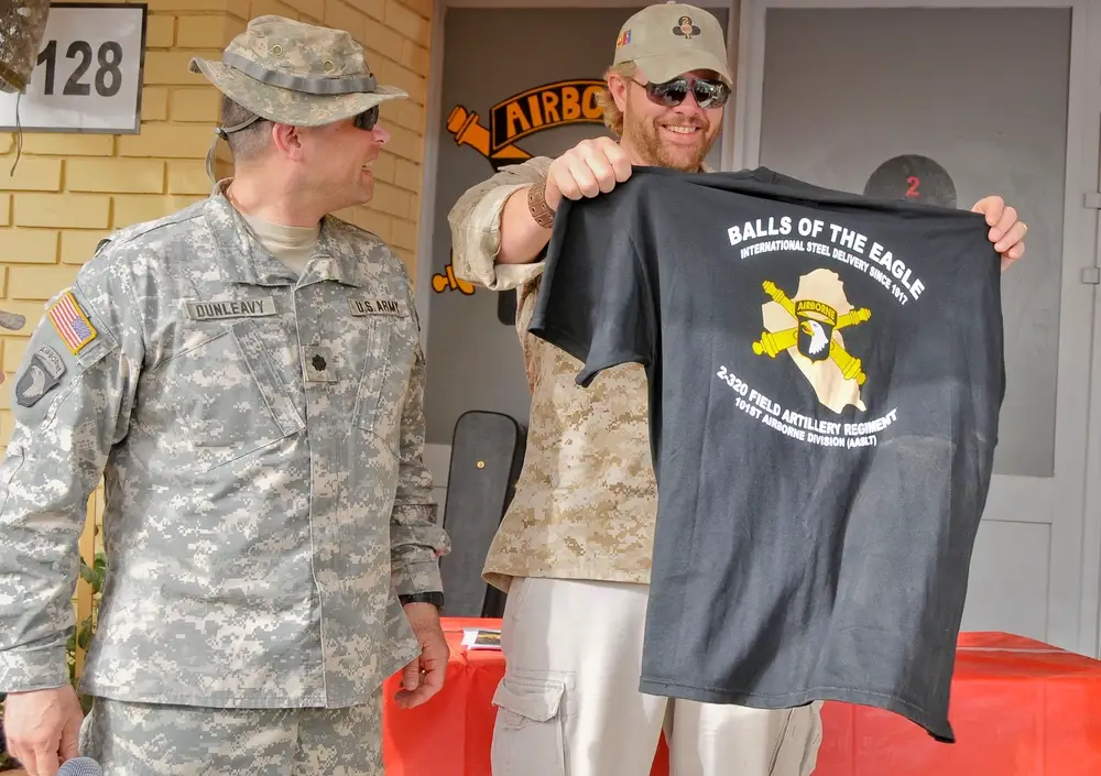 Country music star Toby Keith, checks out his new "Balls of the Eagle" t-shirt that was presented to him by Lt. Col. John Dunleavy, commander of 2nd Battalion, 320th Field Artillery Regiment, 1st Brigade Combat Team, 101st Airborne Division (Air Assault), at Logistical Supply Area Anaconda, Iraq, on April 28, 2008. Keith visited the 2-320th FAR to meet with Soldiers and take part in a re-enlistment at the battalion headquarters.