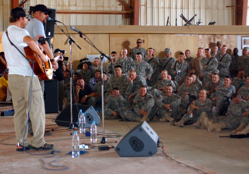 Toby Keith sings one of his 'bus songs' to a crowd of Soldiers from the 3rd Heavy Brigade Combat Team, 4th Infantry Division, Task Force Band of Brothers at Forward Operating Base Warhorse (Baqubah, Iraq) May 29, 2006. U.S. Army photo.