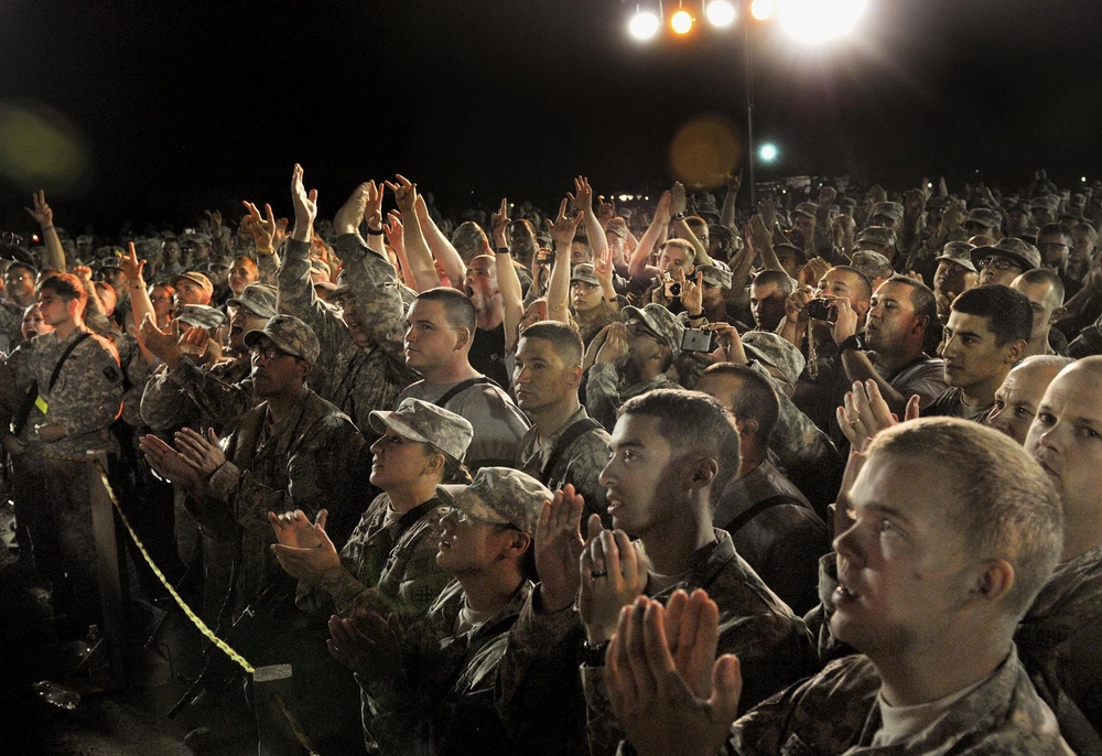 Crowd cheers for Toby Keith: Hundreds of U.S. Division-North service members and civilians cheer for country music star Toby Keith during Keith's "Locked and Loaded" tour at Contingency Operating Base Speicher, Iraq, April 27, 2011. Currently on his ninth visit to Iraq, Keith performed a variety of his hits as well as military-themed songs during the USO-sponsored concert. U.S. Army photo.