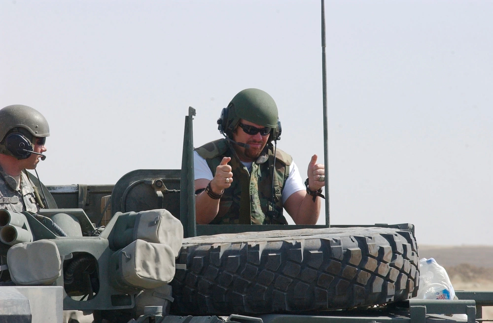 Country singer Toby Keith stands in an air gunners hatch of a Stryker Brigade Combat Vehicle. Keith performs for Soldiers and civilians on Forward Operating base Marez, Mosul, Iraq, May 2006. U.S. Army photo.