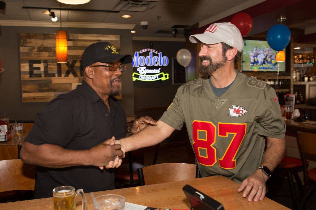 Actor and Retired United States Marine Corps Officer Rob Riggle (right) attends Applebee's Neighborhood Grill &amp; Bar and Serves Free Meals To Military Heroes On Veteran's Day on November 11, 2018 in Los Angeles, California.  (Photo by Alison Buck/Getty Images for Applebee's)