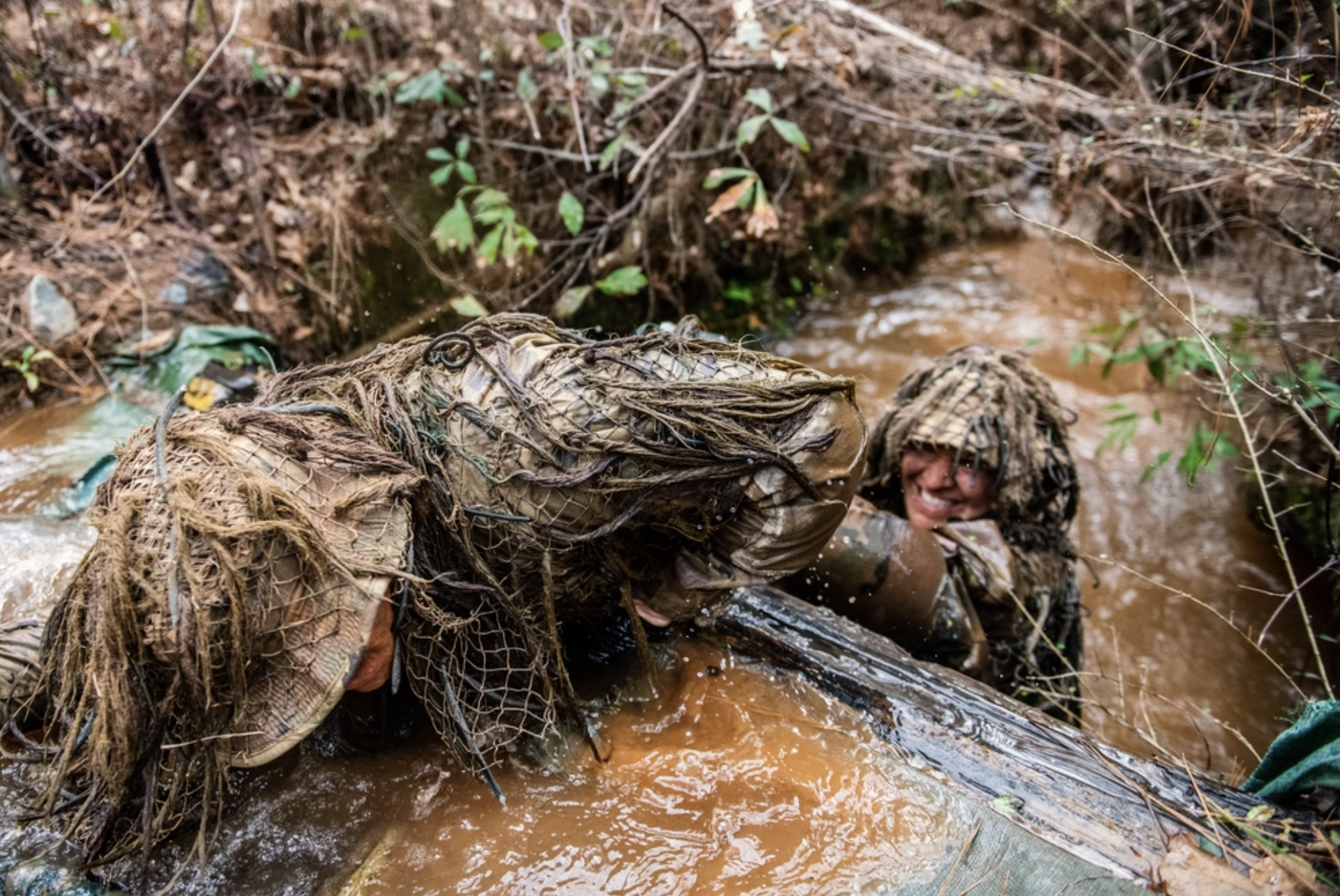 (Fort Benning, Ga) – In Week 3 of U.S. Army Sniper School, 35 students participate in the ghillie wash, which is designed to test the strength and durability of the suits as well as weather them. Sniper School students use sand, water and mud, all in an effort to perfect one of their most important tools: their camouflage. (U.S. Army photo by Patrick A. Albright, Maneuver Center of Excellence and Fort Benning Public Affairs)