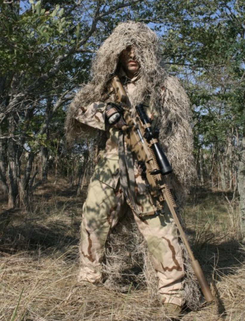 A promo ad for a ghillie suit in a desert camo pattern