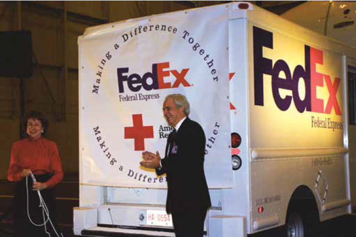 Frederick W. Smith with Senator Elizabeth Dole, head of the American Red Cross, during the announcement of FedEx’s support for worldwide disaster relief. Photo courtesy of Frederick W. Smith.