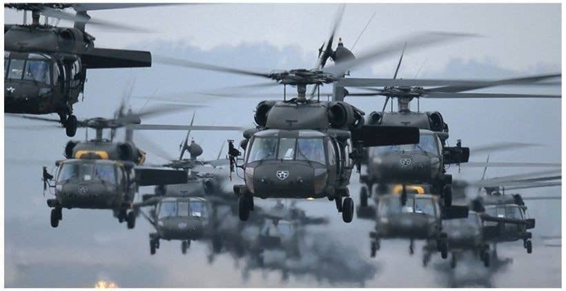 Pilots, from 2nd Battalion (Assault), 2nd Aviation Regiment and 3rd General Support Aviation Battalion, flew in more than 300 Republic of Korea and U.S. Marines on 25 UH-60 Black Hawk helicopters for an air assault, March 13, 2014, on the multipurpose range complex.