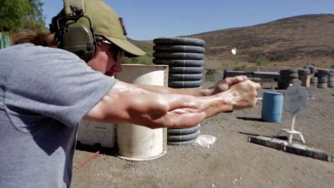 Delta Force veteran Tyler Grey fires a pistol at a desert range. His right arm was wounded during a firefight in Iraq. (Image: Armed Forces Foundation)
