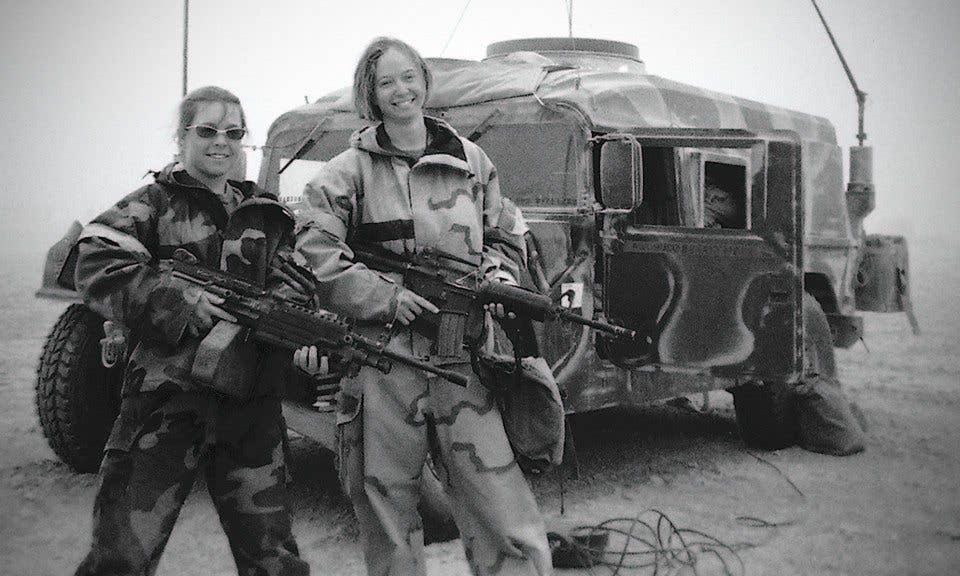 The author (right) rockin' her rifle while tooling around Iraq back in the day.