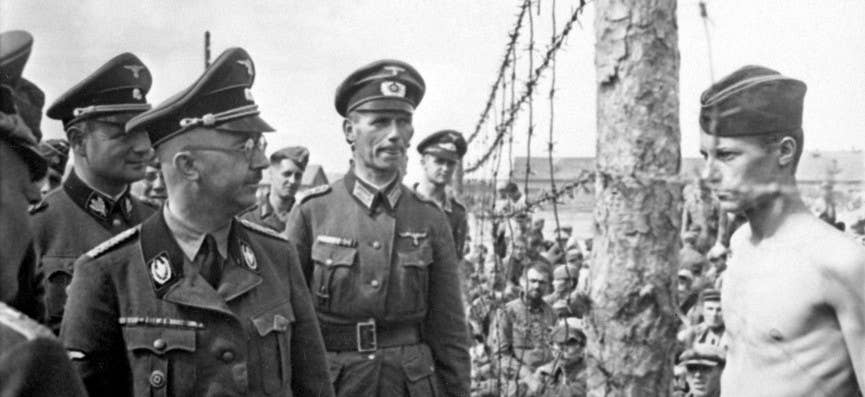 A thin but defiant Horace Greasley stares down Heinrich Himmler during a prison inspection. Photo: Wiki Commons