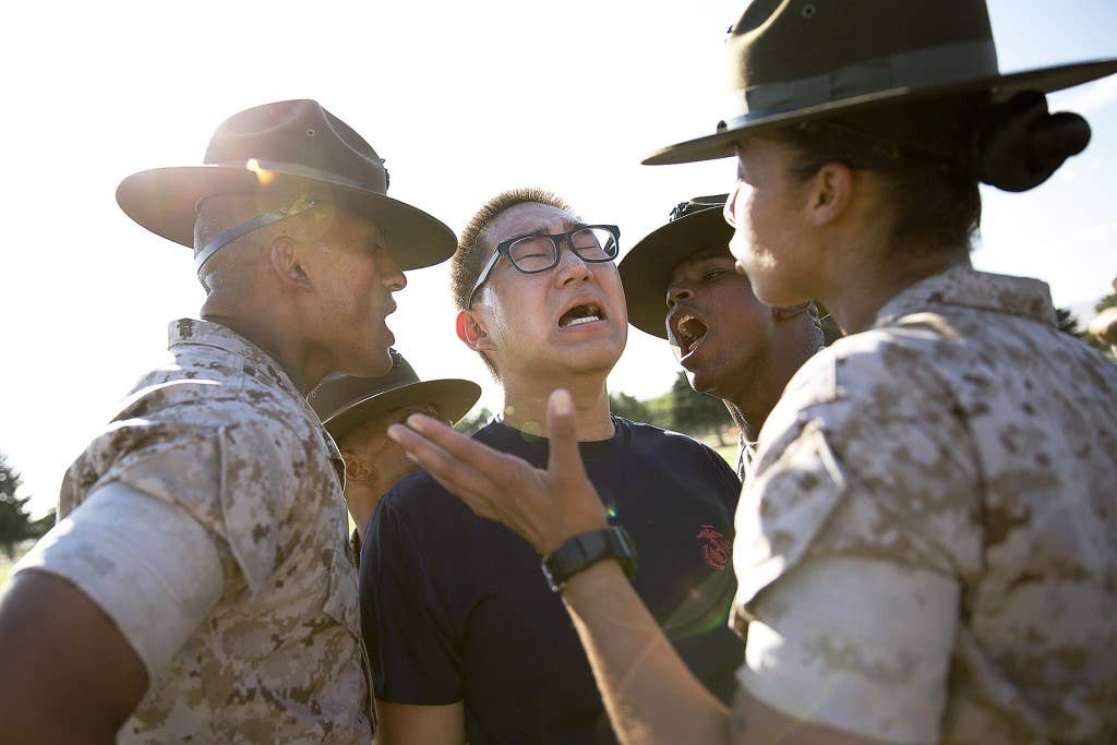 Seung Gwon Cho (center), a Marine enlistee from Lynnwood, Wash., responds to corrections from drill instructors Sgts. Aldo Valencia (left), Julian Taylor (second from left), Donald Jackson (second from right) and Tina Quevedo (right) during a Recruiting Station Seattle pool function at the Yakima Training Center in Yakima, Wash., July 17, 2015. During the event, recruiters teamed with drill instructors to physically and mentally prepare enlistees from Washington and Idaho for boot camp. The enlistees, part of the Marine Corps delayed entry program, are awaiting their ship dates. Cho, 18, graduated from Meadowdale High School and was recruited by Sgt. Ricardo Schebesta. Valencia, 25, is from Denver and is assigned to Delta Company, 1st Recruit Training Battalion. Taylor, 26, is from St. Augustine, Fla., and is assigned to Lima Company, 3rd Recruit Training Battalion. Jackson, 28, is from Suffolk, Va., and is assigned to MCRD San Diego. Quevedo, 24, is from Long Beach, Calif., and is currently assigned to November Company, 4th Recruit Training Battalion. (U.S Marine Corps photo by Sgt. Reece Lodder)