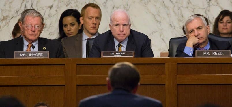 Senate Armed Services Committee Chairman Sen. John McCain, R-Ariz., Ranking Member Sen. Jack Reed, D-R.I., and Sen. Jim Inhofe, R-Okla., listen as retired Gen. David Petraeus testifies at a hearing in Washington, Sept. 22, 2015.