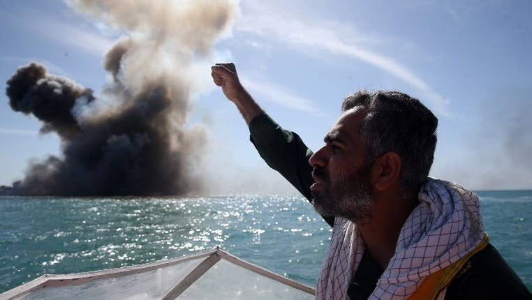 A member of Iran's elite Revolutionary Guards chants slogans after attacking a naval vessel during a military drill in the Strait of Hormuz in southern Iran, February 25, 2015. (Photo: Hamed Jafarnejad/AFP/Fars News)
