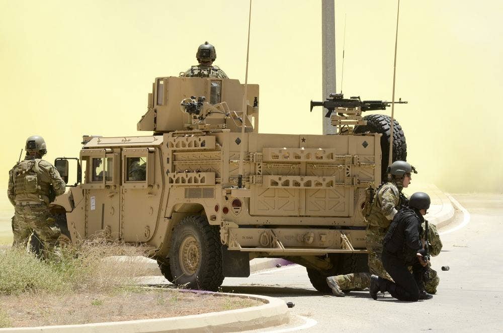 Special operators gather around an up-armored Humvee. (Photo: DVIDS)