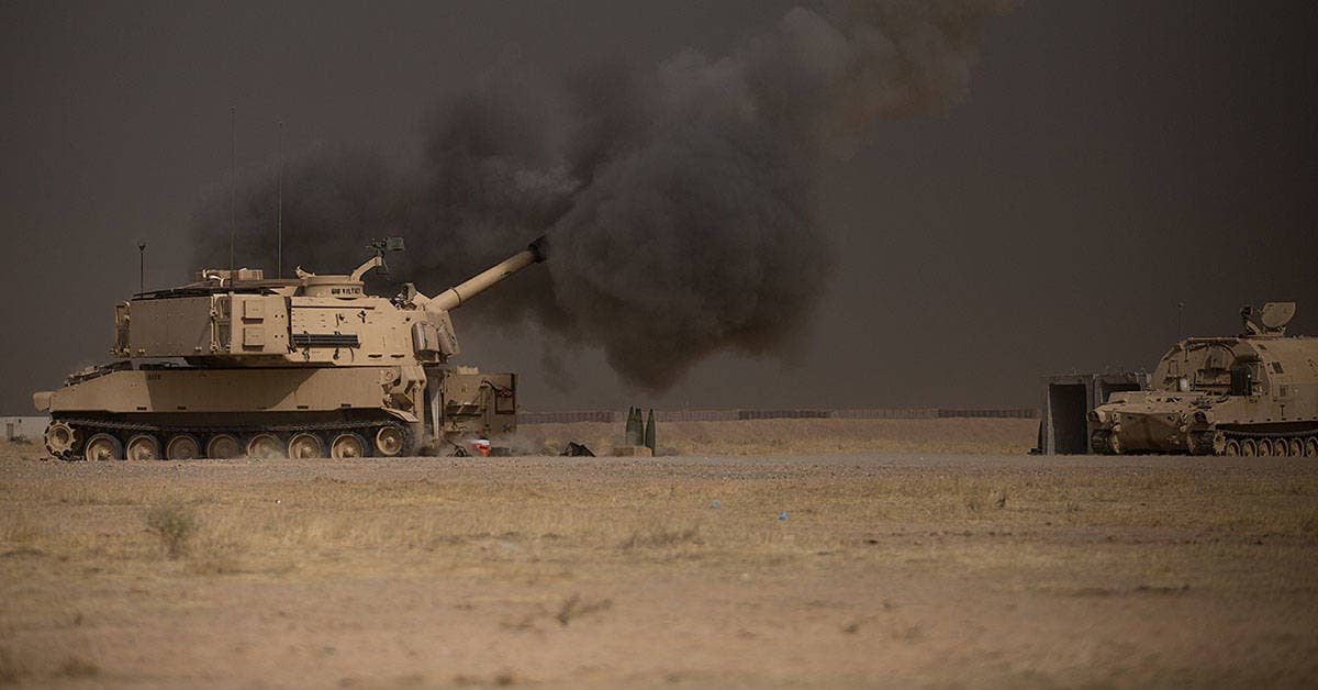 A US Army M109A6 Paladin conducts a fire mission at Qayyarah West, Iraq. US Army photo by Spc. Christopher Brecht.