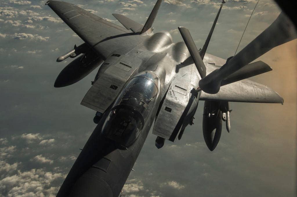 A U.S. Air Force KC-135 Stratotanker from the 340th Expeditionary Air Refueling Squadron refuels a F-15 Strike Eagle in support of Operation Inherent Resolve, Dec. 28, 2015. OIR is the coalition intervention against the Islamic State of Iraq and the Levant. (U.S. Air Force photo by Tech. Sgt. Nathan Lipscomb)