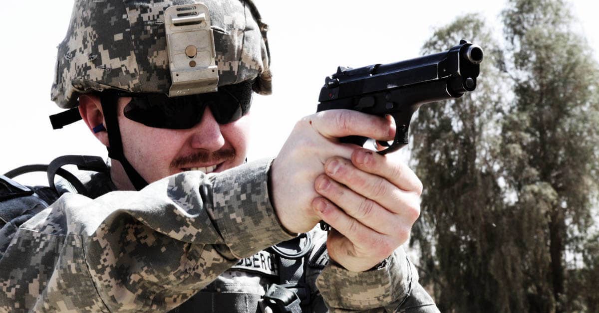 A soldier fires a Beretta M9 pistol. Photo from US Army.