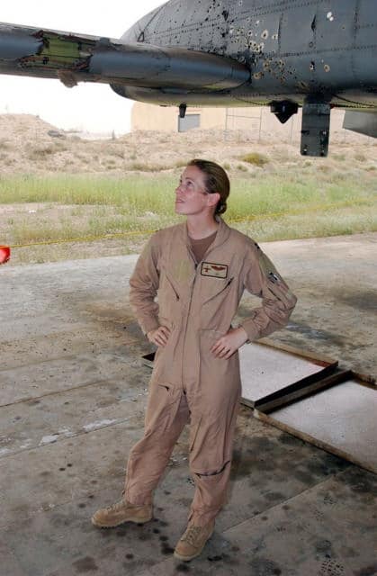 Kim Campbell looks at her damaged hog, which she landed at her base after a mission over Baghdad in 2003. (Photo via National Air and Space Museum)