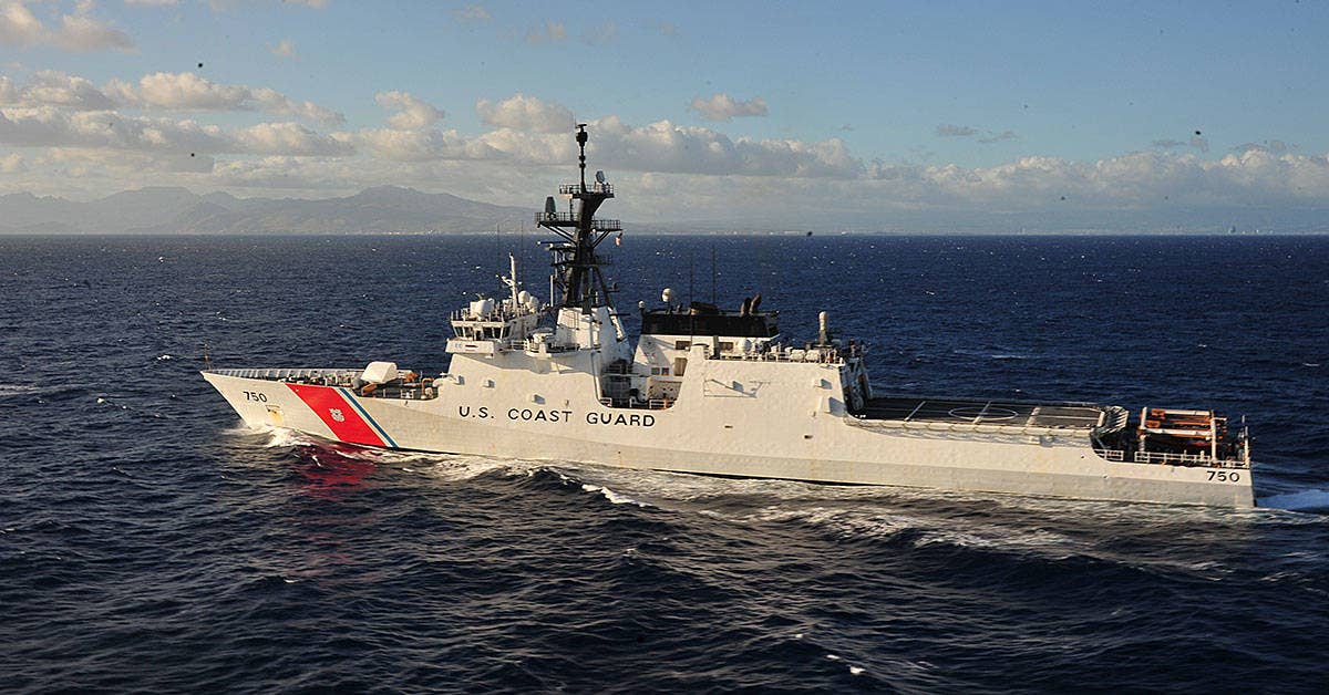 The Coast Guard Cutter Bertholf steams off the coast of Oahu to perform training with an aircrew piloting an MH-65 Dolphin helicopter from Air Station Barbers Point, June 27, 2011. (U.S. Coast Guard photo by Petty Officer 3rd Class Anthony L. Soto)