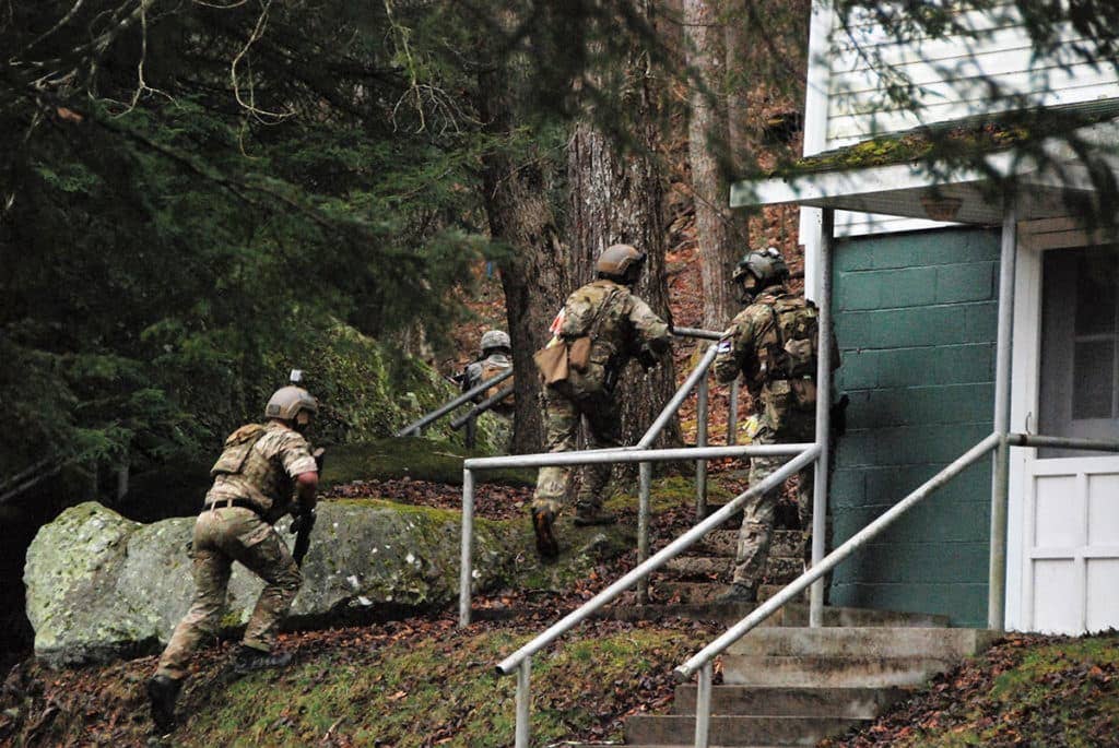 Estonian Special Operations Force soldiers, along with U.S. Army Special Operations Forces Soldiers with 10th Special Forces Group (Airborne) and soldiers of the West Virginia National Guard, quickly move to assault a building containing high-value adversary targets during an air-assault training exercise as part of Exercise Ridge Runner Feb. 23, 2017 in West Virginia. (U.S. Army photo by Sgt. 1st Class Jeff Smith)