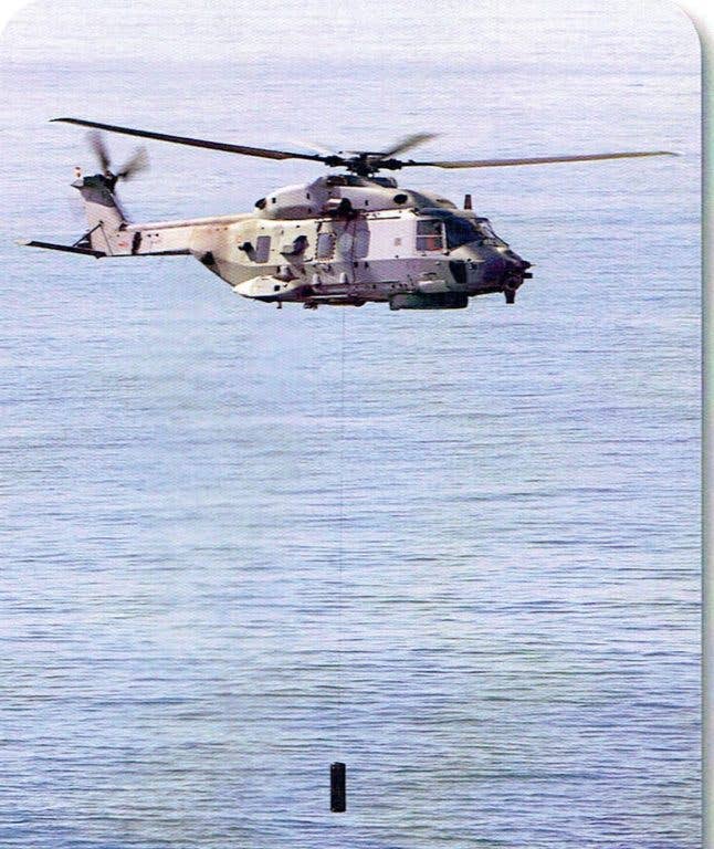 A helicopter uses the HELRAS dipping sonar. (Scanned and cropped from L3 handout)