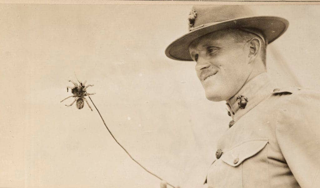 A U.S. Marine at Marine Corps Training Activity San Juan, Cuba, shows off the tarantula he found. Tarantulas commonly crawled into the Marines' boots at night. (Photo: National Archives and Records Administration)