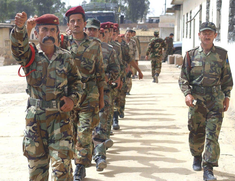 The Kurdish Peshmerga platoon of the Joint Iraqi Security Company marches to class, Mosul, Iraq. (Dept. of Defense photo)