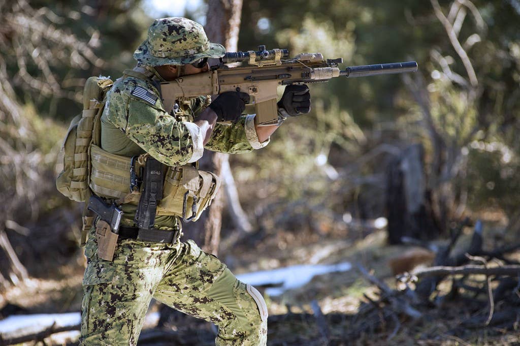 A US Navy SEAL aims his SCAR during training. Photo: US Navy Mass Communication Specialist 2nd Class Martin L. Carey