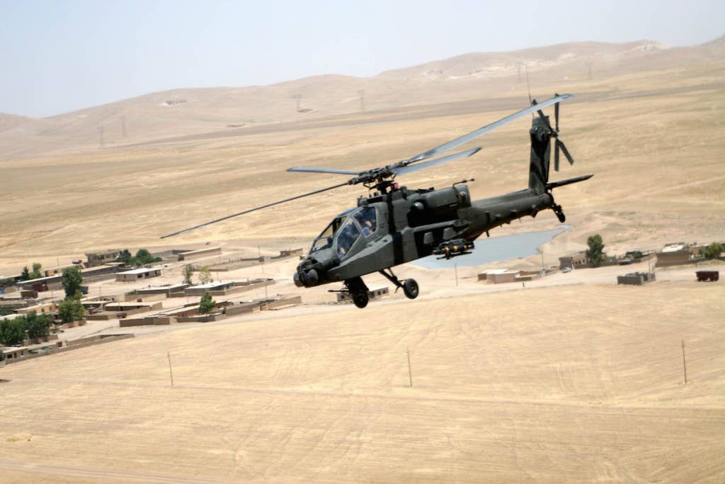 An AH-64D Apache Longbow attack helicopter flies over the desert terrain between Tall'Afar and Mosul, Iraq. | US Army photo by Staff Sgt. Ryan Matson