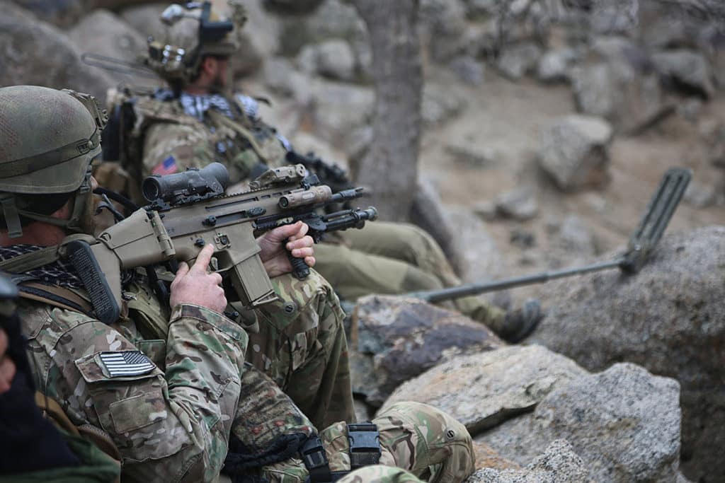 A Special Forces soldier takes a rest during a patrol in Afghanistan. The Army is considering outfitting its front-line troops with a 7.62 battle rifle like this Mk17 SCAR-H. (Photo from US Army Special Operations Command)