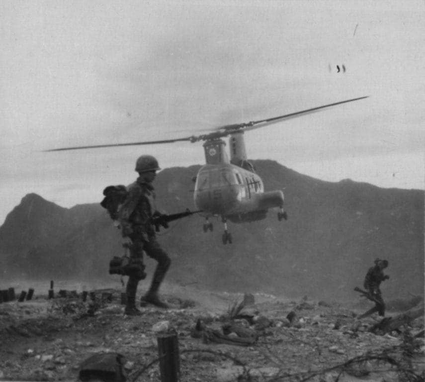 An ARVN Ranger and a CH-46D helicopter from Marine Medium Helicopter Squadron 263 are silhouetted against the early morning sky near An Hoa. The Rangers were participating in Operation Durham Peak. (Photo: U.S. Marine Corps Gunnery Sgt. Bob Jordan)