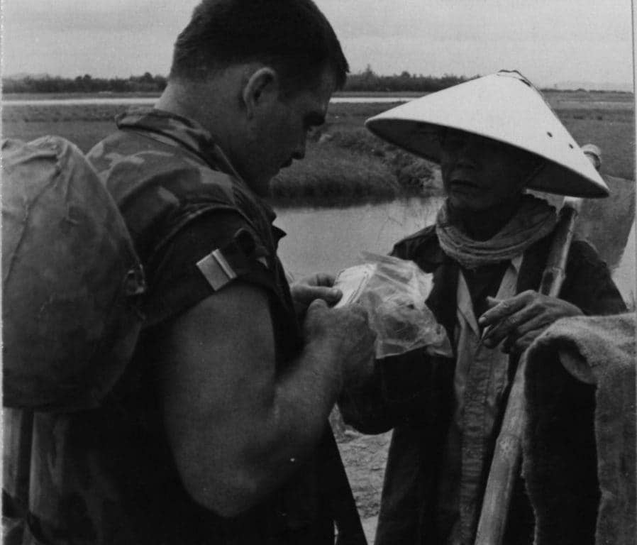 Marine Sgt. Williams 'Budda' Biller of the Combat Action Program makes a routine check of a villager's ID Card. (Photo: U.S. Marine Corps Sgt. H.M. Smith)