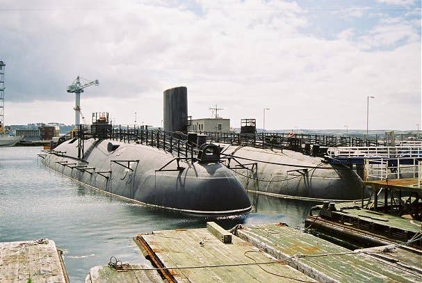 This 2006 photo HMS Conqueror (on the right in the foreground) show her awaiting scrapping. (Photo from Wikimedia Commons)