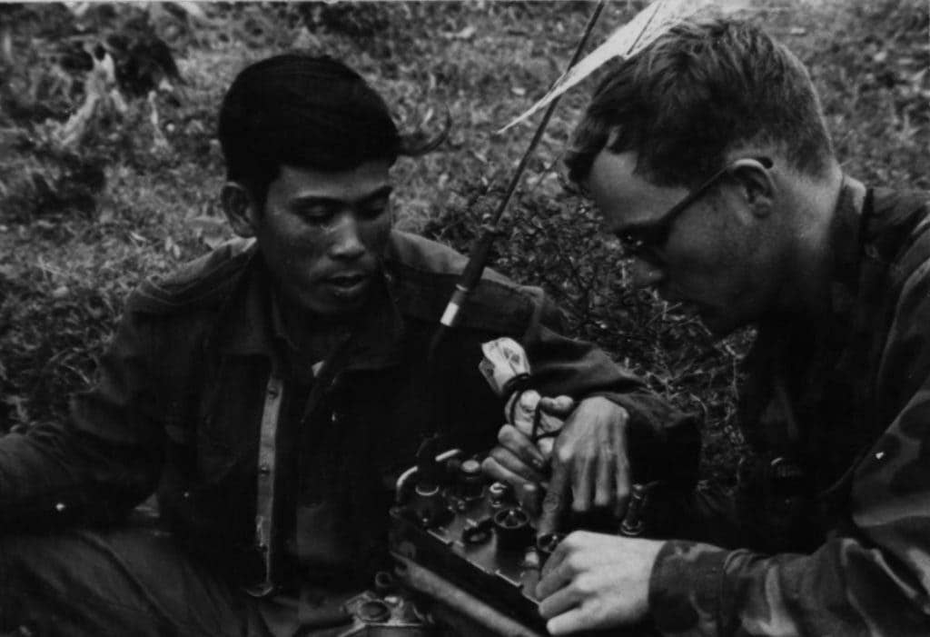 Marine Cpl. J. R. Stien gives a Popular Force soldier an instruction on the operation of the PRC-25 in late-November 1969. (Photo: U.S. Marine Corps Cpl. G. J. Voljack).