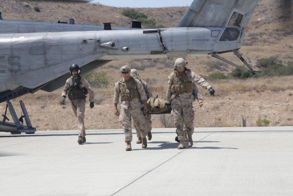 U.S. Navy corpsmen from 1st Medical Battalion rush a casualty off an MV-22B Osprey after a simulated combat-related trauma at Marine Corps Air Ground Combat Center Twentynine Palms, California to a treatment facility at Camp Pendleton, July 29, 2016. The Warfighting Lab identifies possible challenges of the future, develops new warfighting concepts, and tests new ideas to help develop equipment that meets the challenges of the future operating environment. (U.S. Marine Corps photo by Pfc. Nadia J. Stark/released)