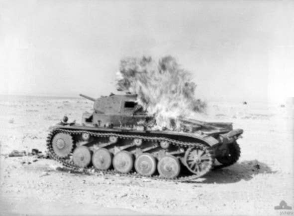 A German Panzer II burns after being hit by a Molotov Cocktail on April 30, 1941. (Photo: Australian Armed Forces)